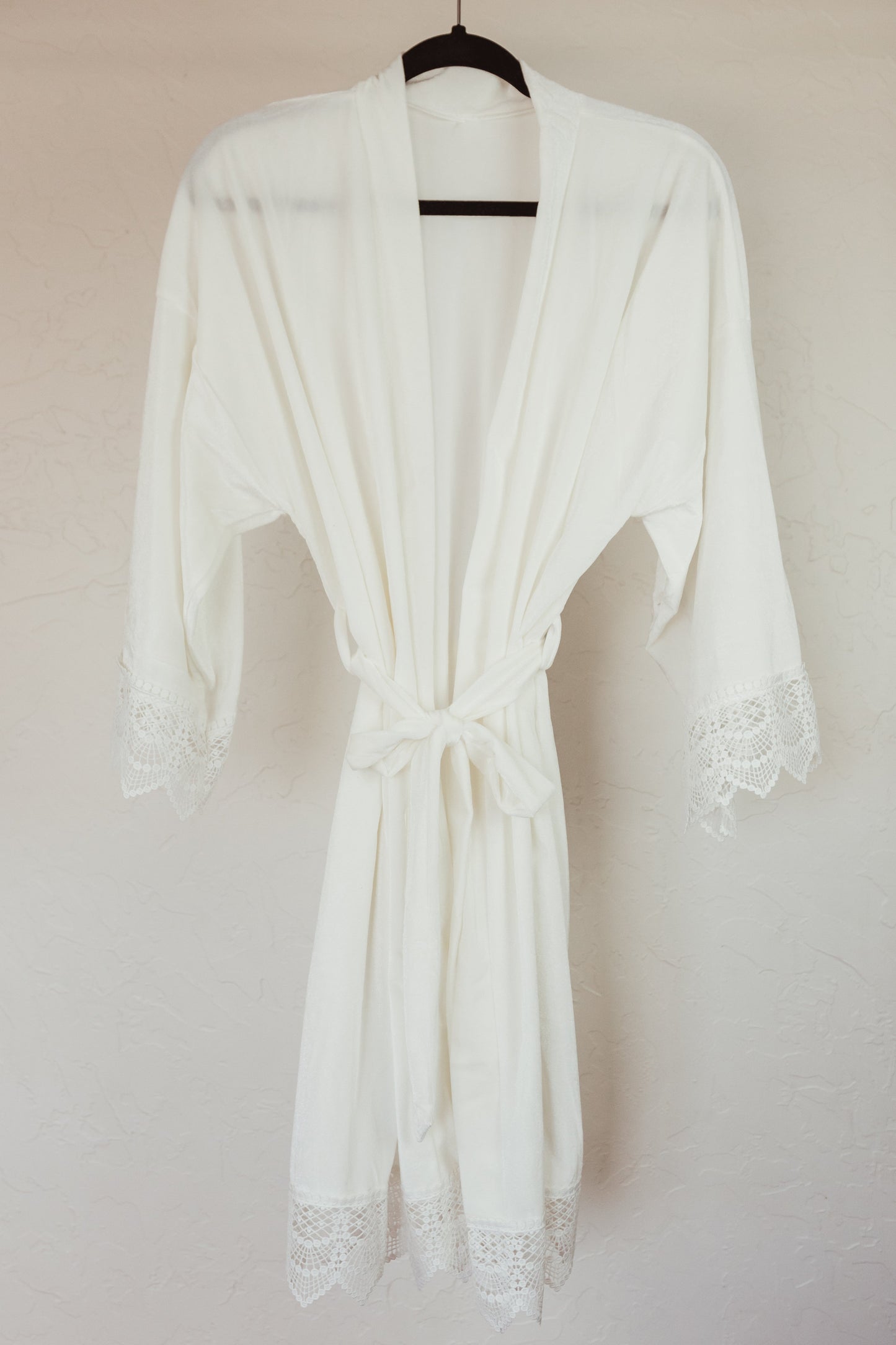 Luxurious velvet robe with lace sleeves, perfect for the bride's getting-ready photos