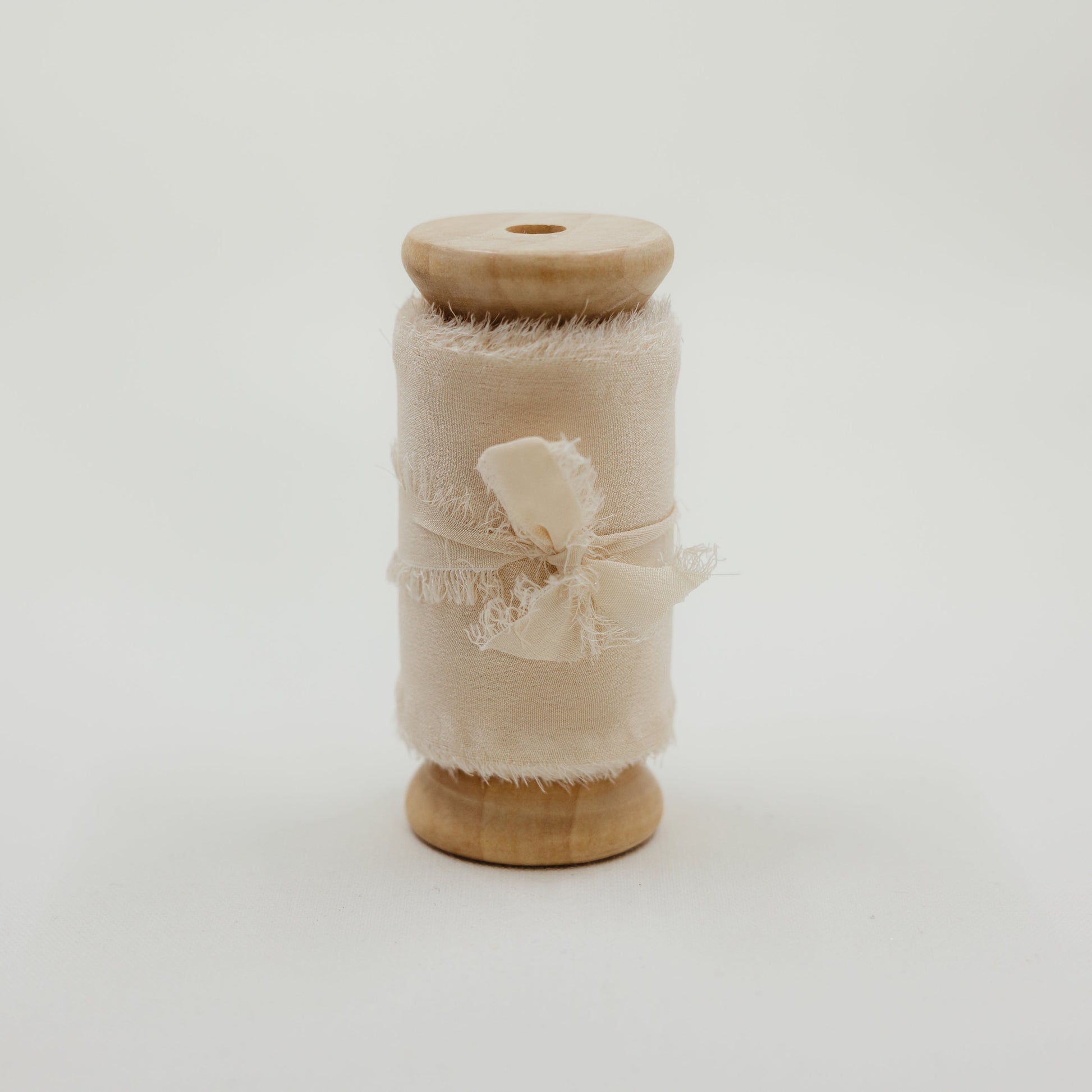 Raw edge, hand-dyed silk ribbon, shown styled in a wedding flat lay with rings and invitation suite