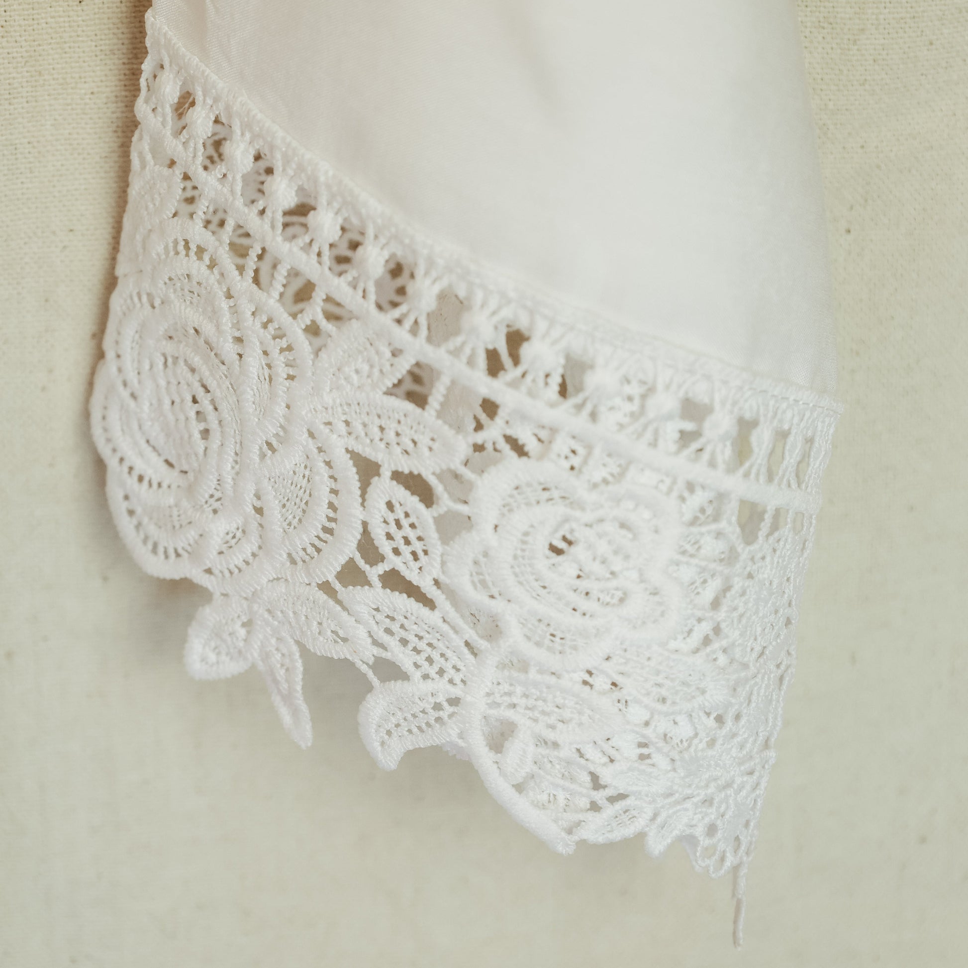 Close Up of Bride Getting Ready Robe in White with Floral Lace Detail on the Sleeves