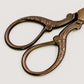Handle Detail of Flat Lay Styling Scissors with Bronze Finish