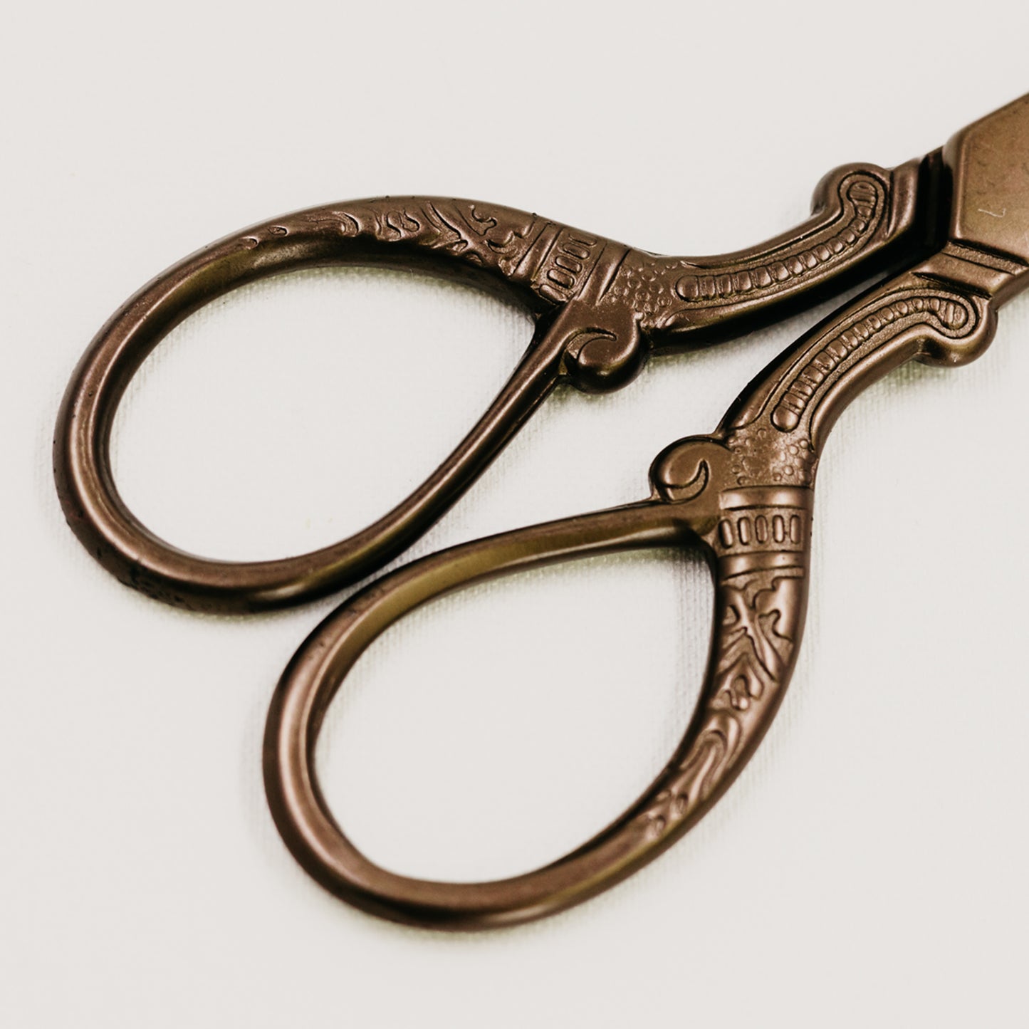 Handle Detail of Flat Lay Styling Scissors with Bronze Finish