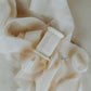 Hand-dyed silk ribbon with a raw edge, used to complement floral arrangements in wedding flat lay photography