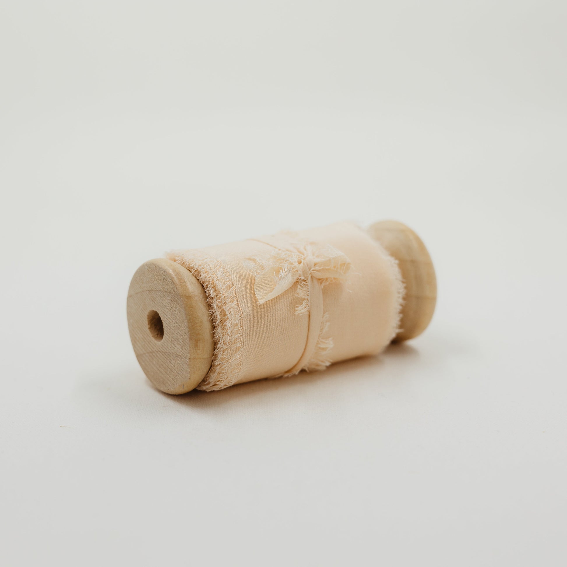 Delicate, hand-dyed silk ribbon with a raw edge, used to enhance detail shots in wedding flat lay styling