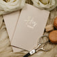 Close-up of a handmade vow book, showing the foiled personalization and soft touch cover, pocket-sized