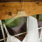A clear acrylic hanger featuring the name 'mrs white' in a gold script font, hanging a white wedding dress.