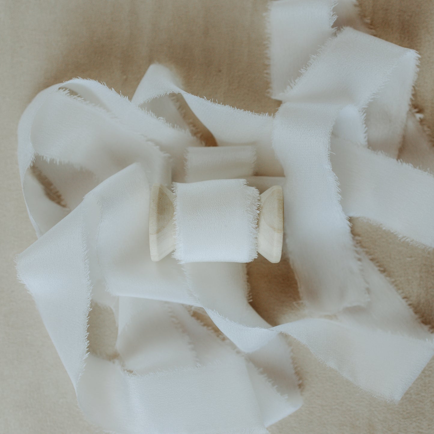 Handmade silk ribbon with a textured raw edge, perfect for wrapping around wedding gifts and showcasing in detail-oriented flat lay photography
