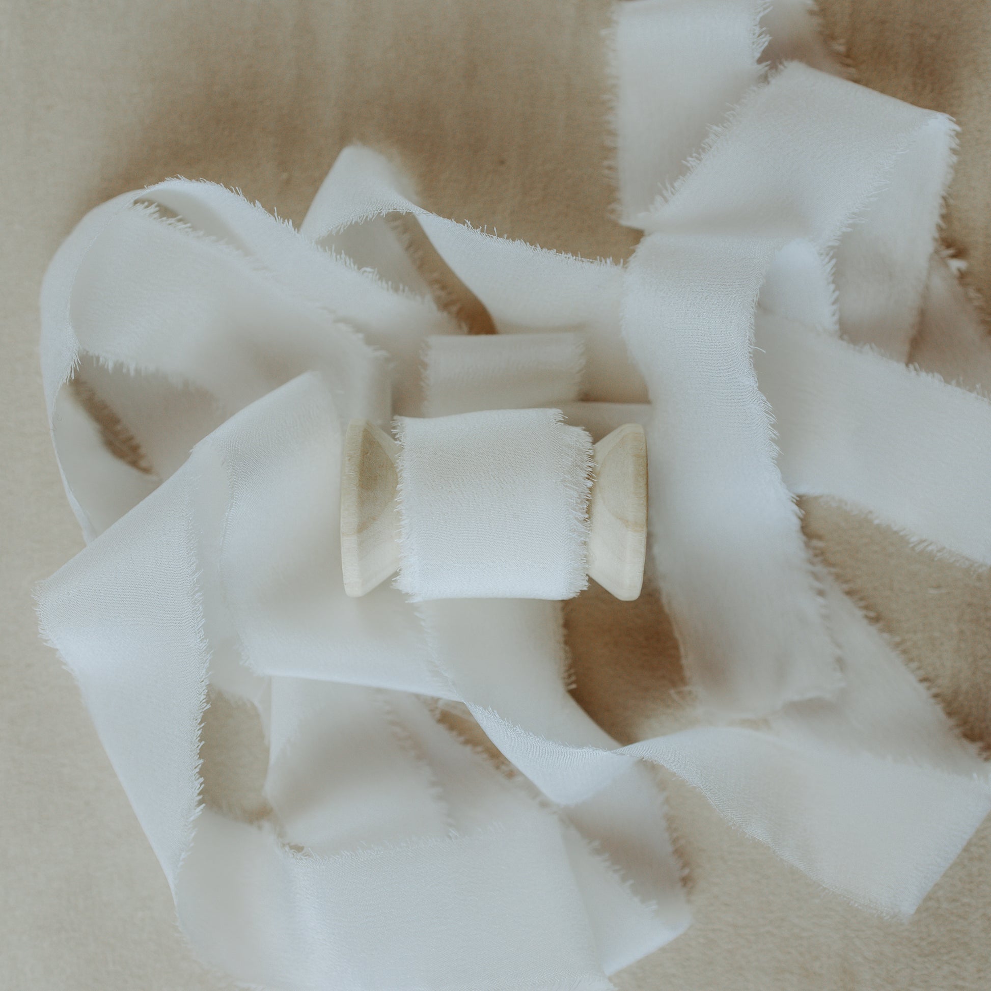 Handmade silk ribbon with a textured raw edge, perfect for wrapping around wedding gifts and showcasing in detail-oriented flat lay photography