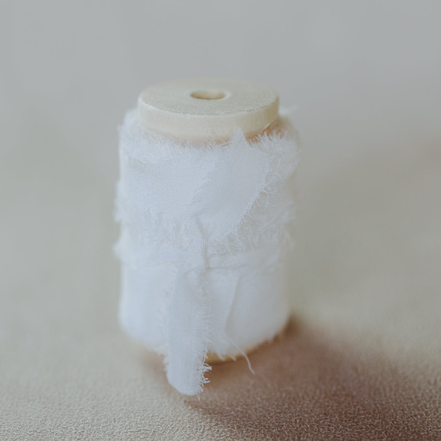 Delicate, hand-dyed silk ribbon with a raw edge, used to add a touch of color and texture to wedding detail flat lays